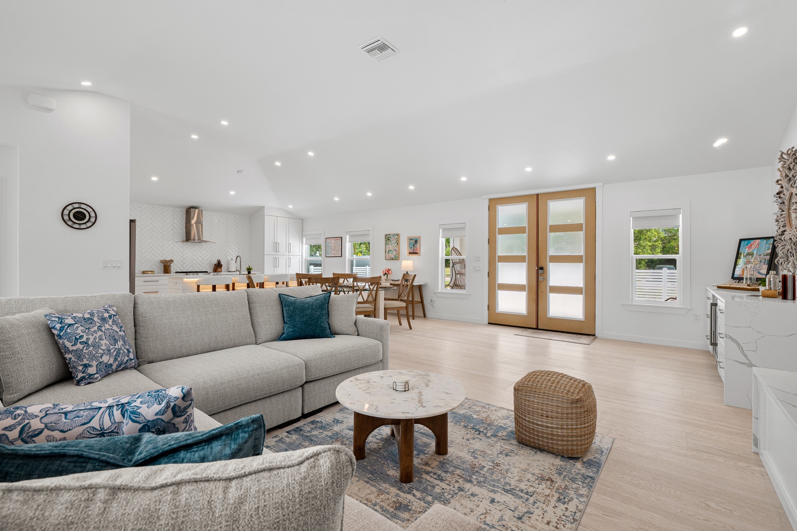 Unwind in your spacious open-plan living area, where natural light pours through elegant French doors and crisp white ceilings create an airy retreat. The modern kitchen awaits your culinary adventures.