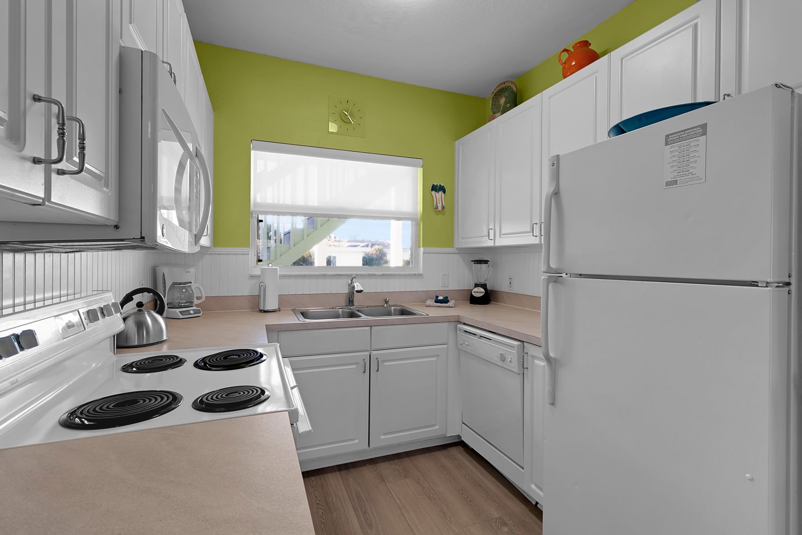 Step into your cheerful, fully equipped kitchen with everything you need to whip up home-cooked meals. Bright walls and modern appliances create a welcoming space to gather and create.