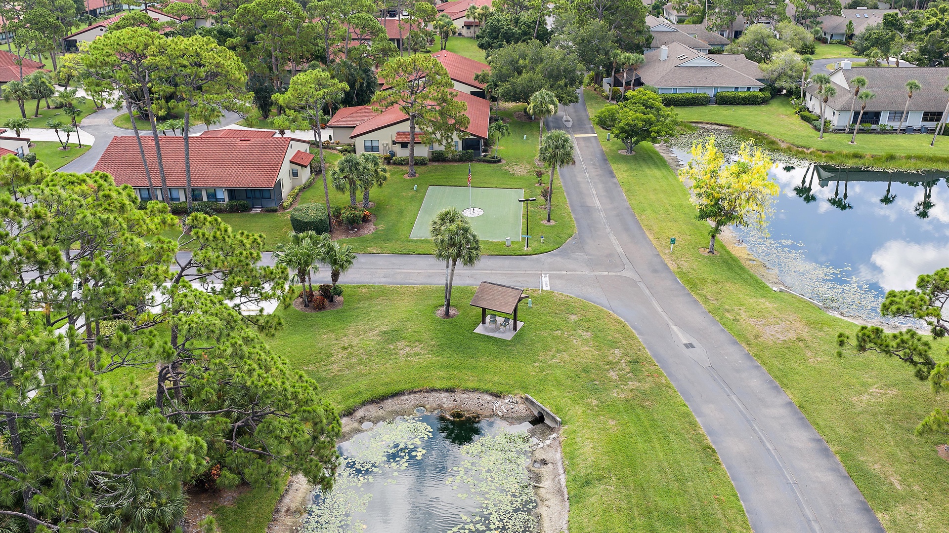 A peaceful residential community featuring tree-lined streets, scenic ponds, and well-maintained green spaces creating a tranquil Florida setting.
