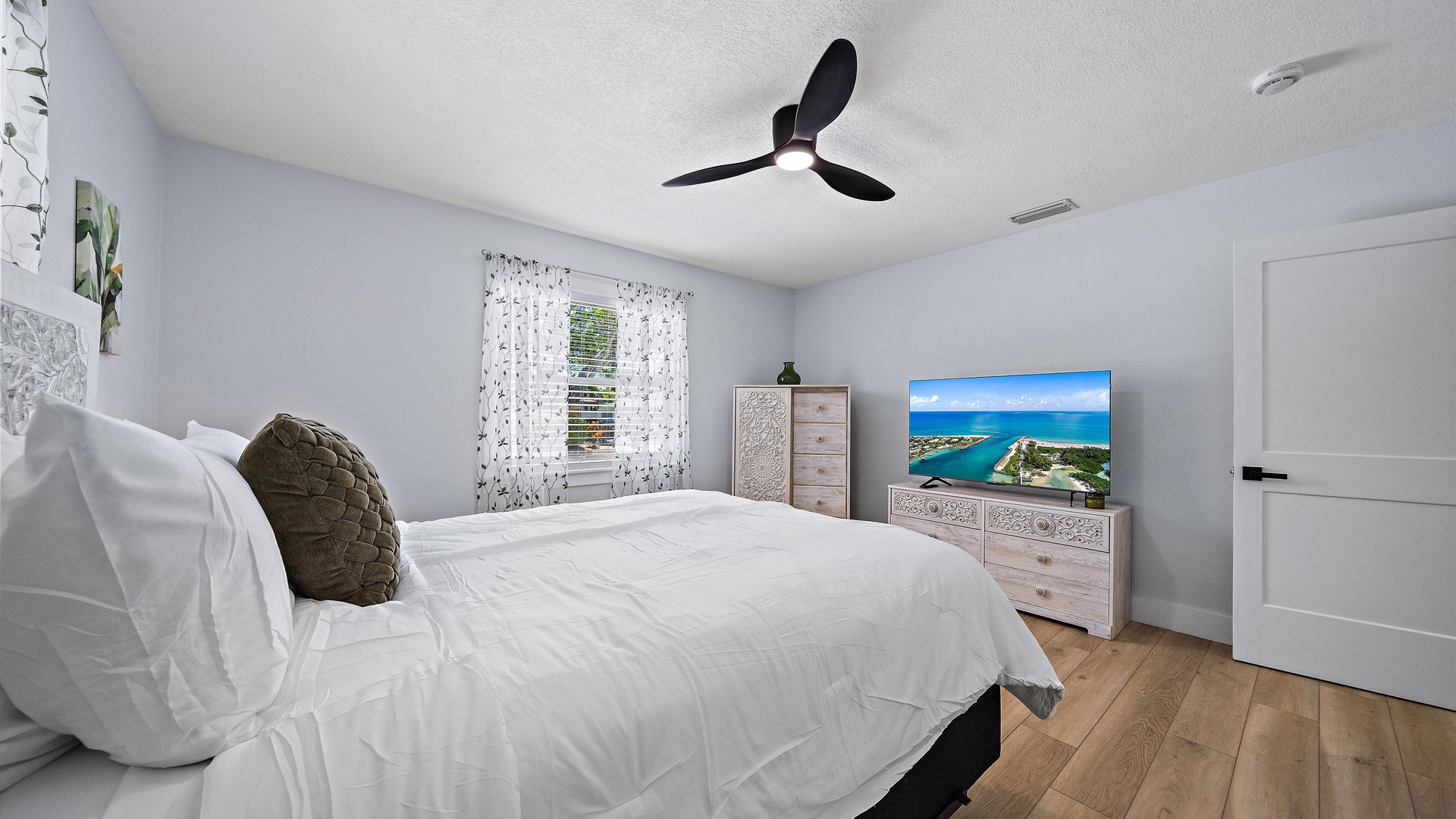 Drift off to sleep in this tranquil bedroom with soft linens, coastal touches, and plenty of natural light from your window.