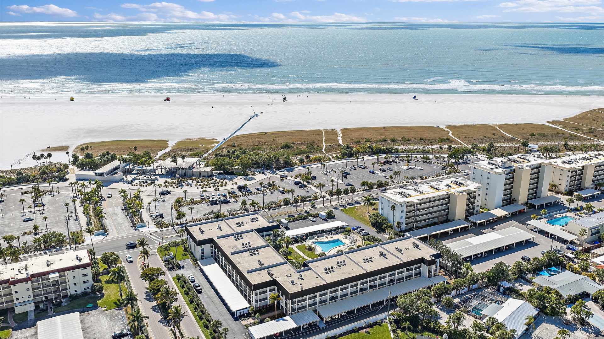 Stunning beachfront properties nestled between pristine white sand and turquoise waters on Florida's Gulf Coast.