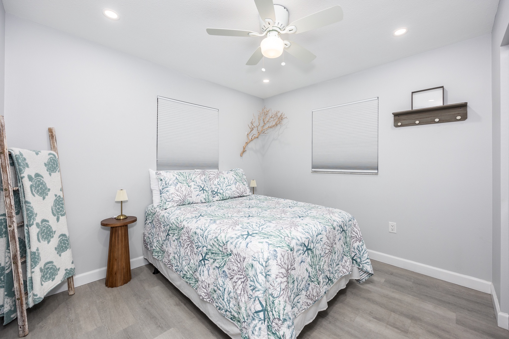 Drift off in your serene retreat, where coastal bedding and gentle ceiling fan create the perfect sleep sanctuary.