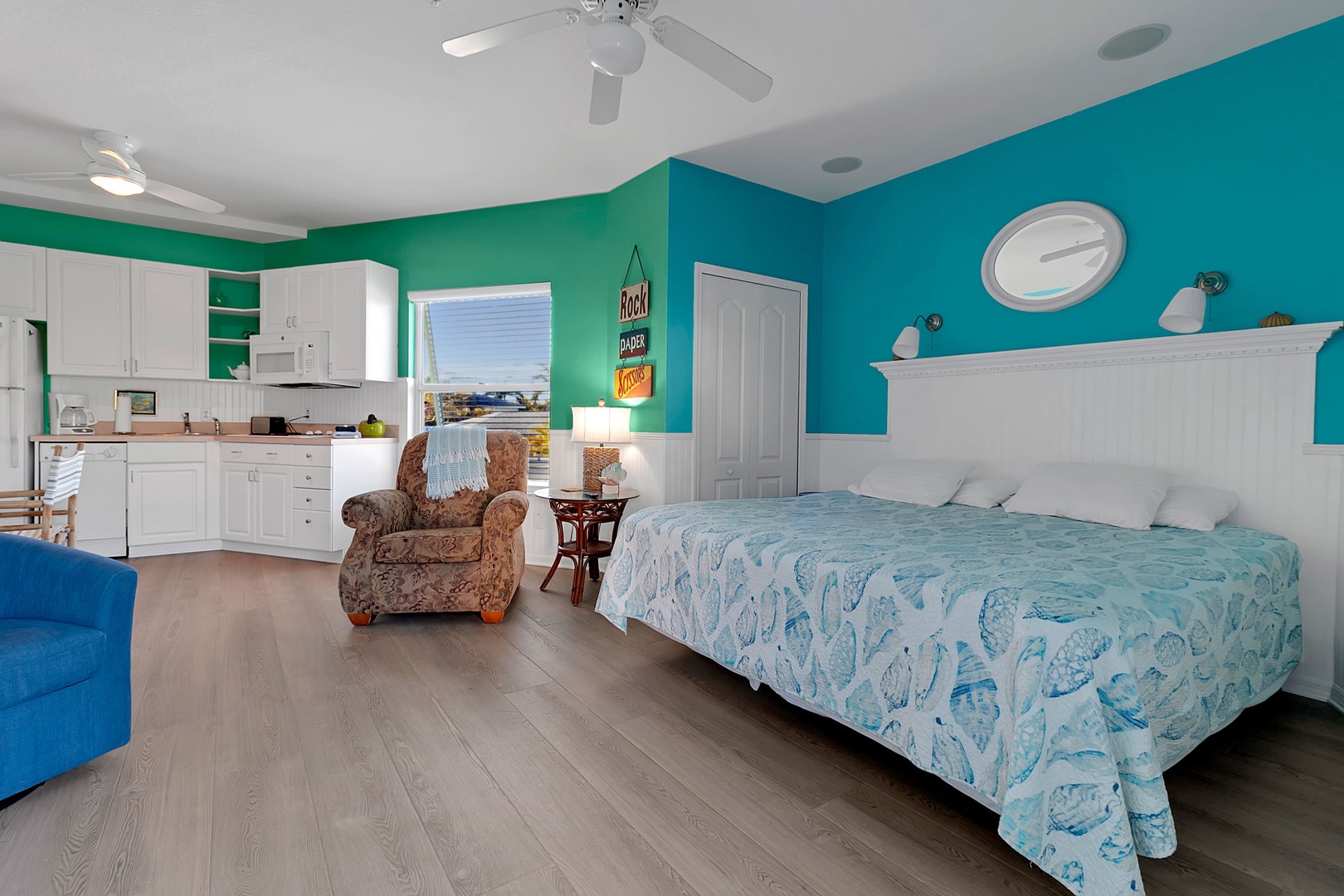 Your vibrant coastal studio features a comfy bed, kitchenette, and cheerful turquoise accents that set the perfect beachy mood for your stay.