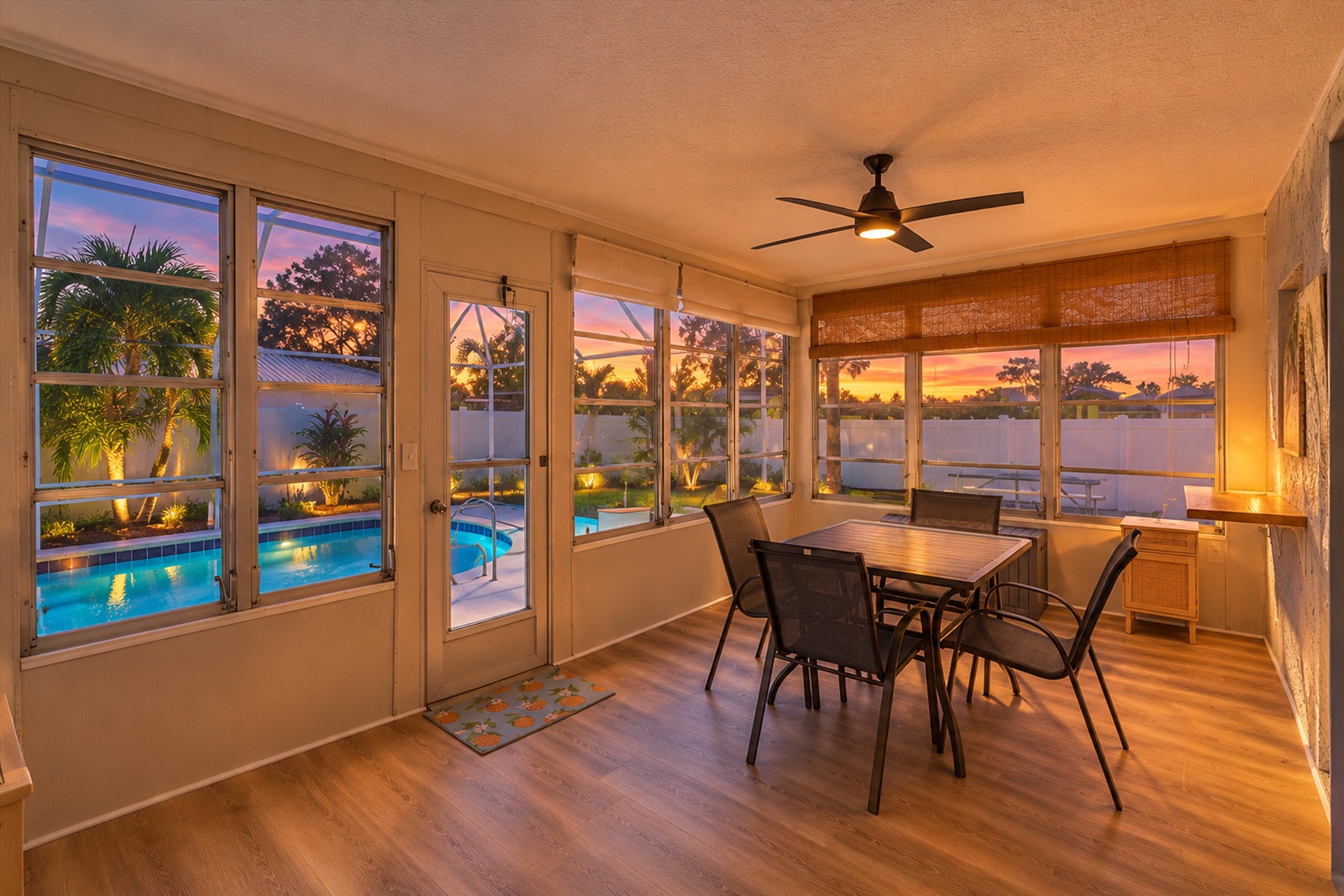 Enjoy evening Florida sunsets in the sunroom overlooking the pool and tropical backyard oasis.