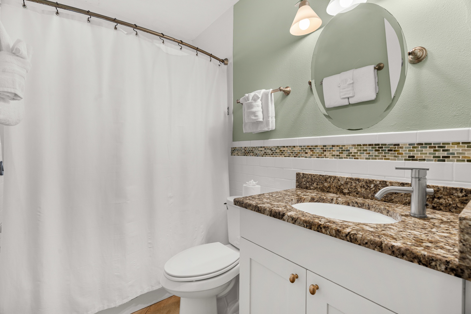Your private bathroom features granite countertops, fresh towels, and everything you need for a comfortable stay.