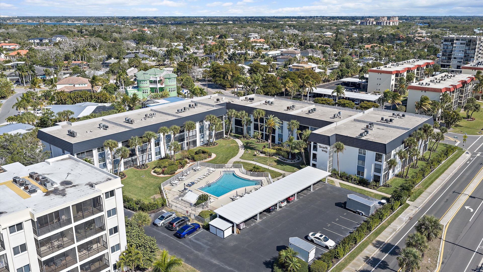 Modern vacation rental property featuring swimming pool and landscaped grounds in a tropical residential neighborhood.