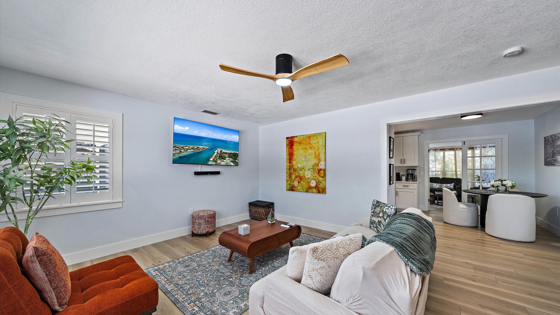 Sink into plush seating and let the coastal breeze from your ceiling fan wash over you in this bright, airy living space—your perfect retreat after a day of adventure.