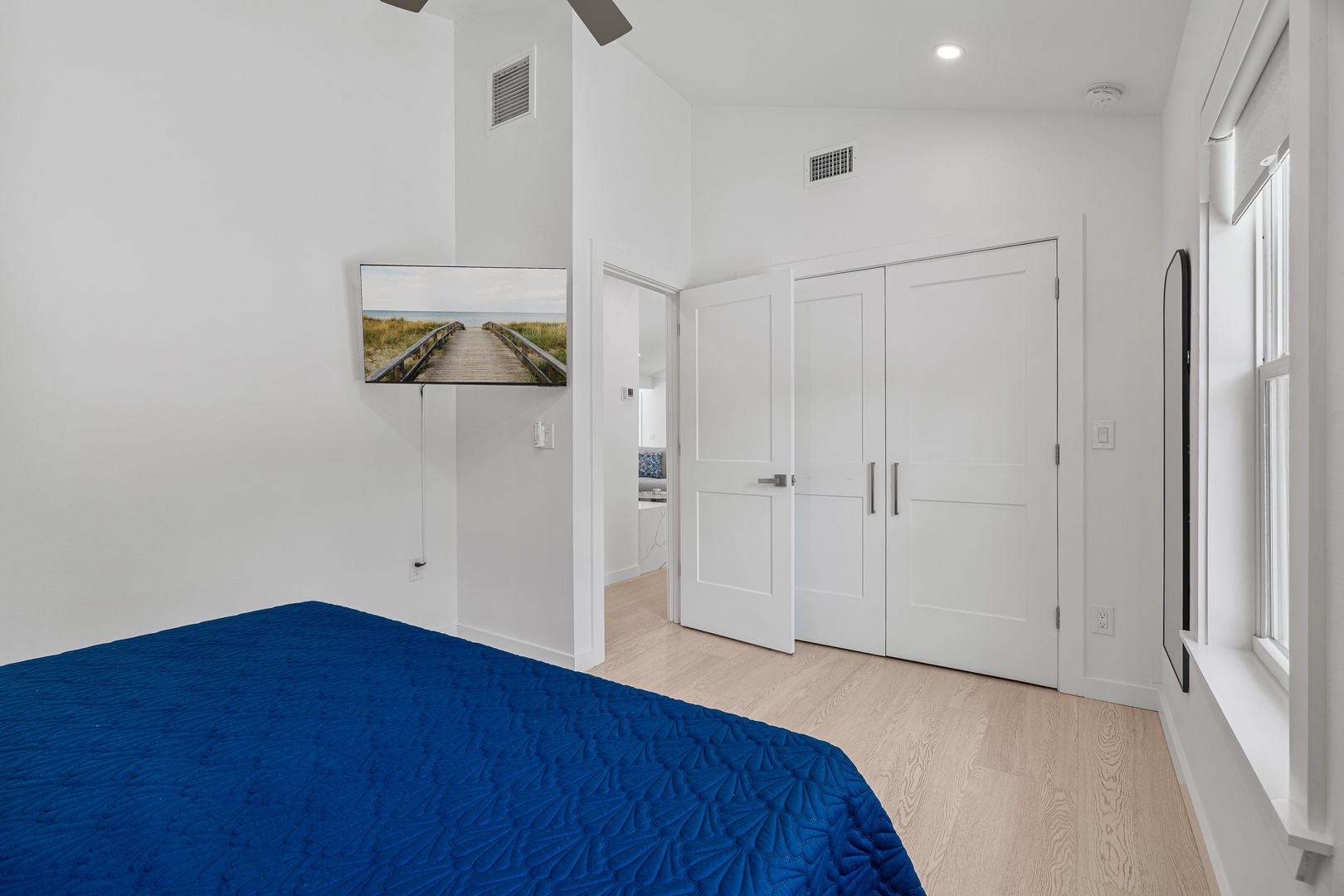 Bright, peaceful bedroom with a cozy bed, clean lines, and plenty of storage to keep your space clutter-free and relaxing.