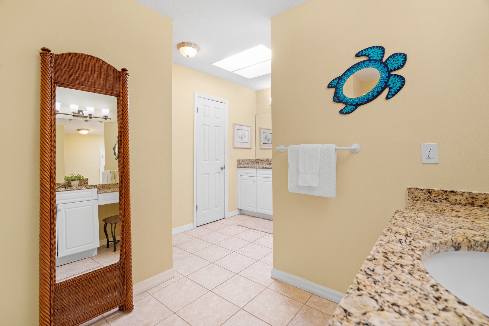 Fresh towels await in your spacious bathroom, complete with granite countertops and charming coastal touches that make getting ready feel effortless.