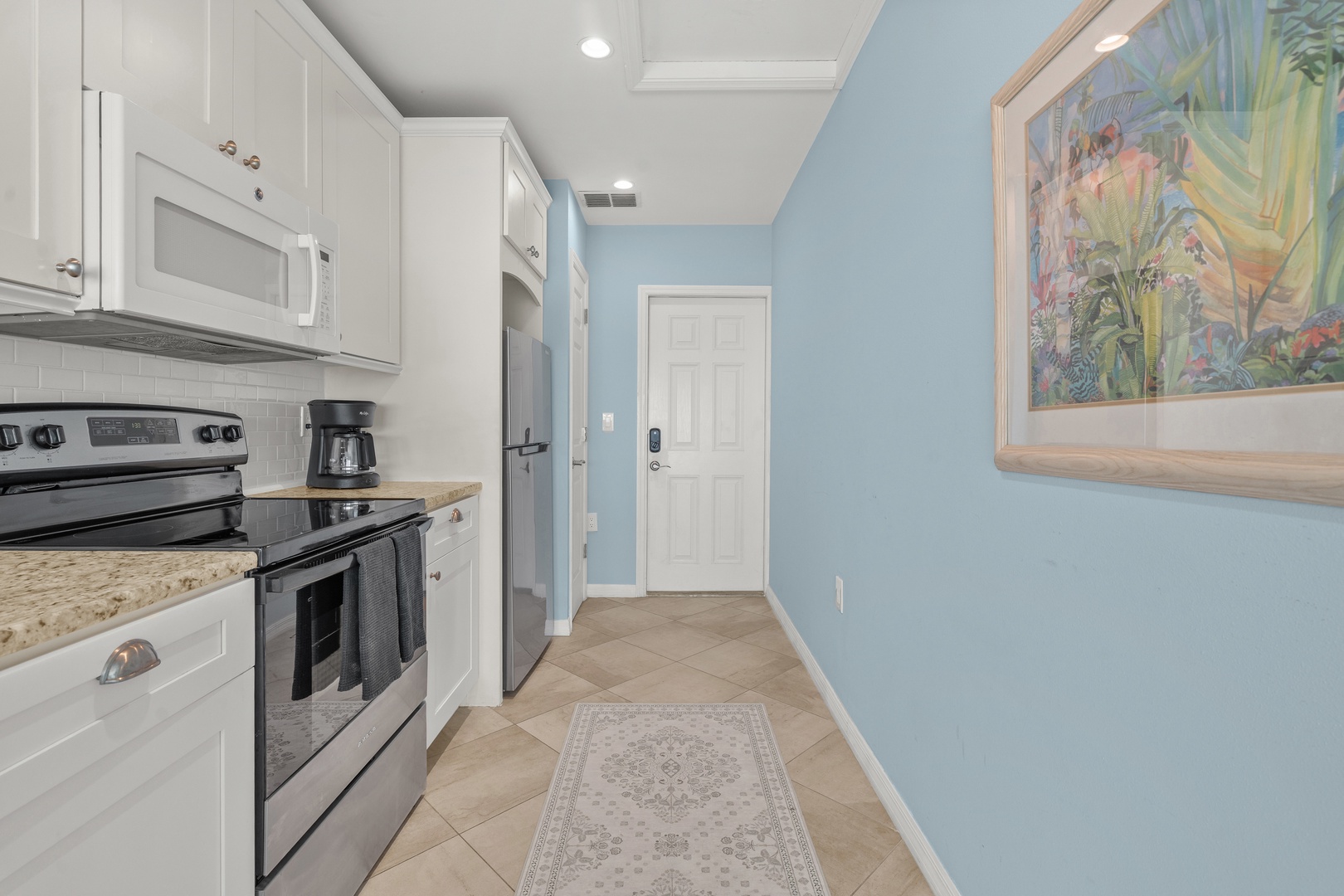 Your fully-equipped kitchen awaits with modern appliances, granite counters, and cheerful coastal vibes for memorable meal prep.