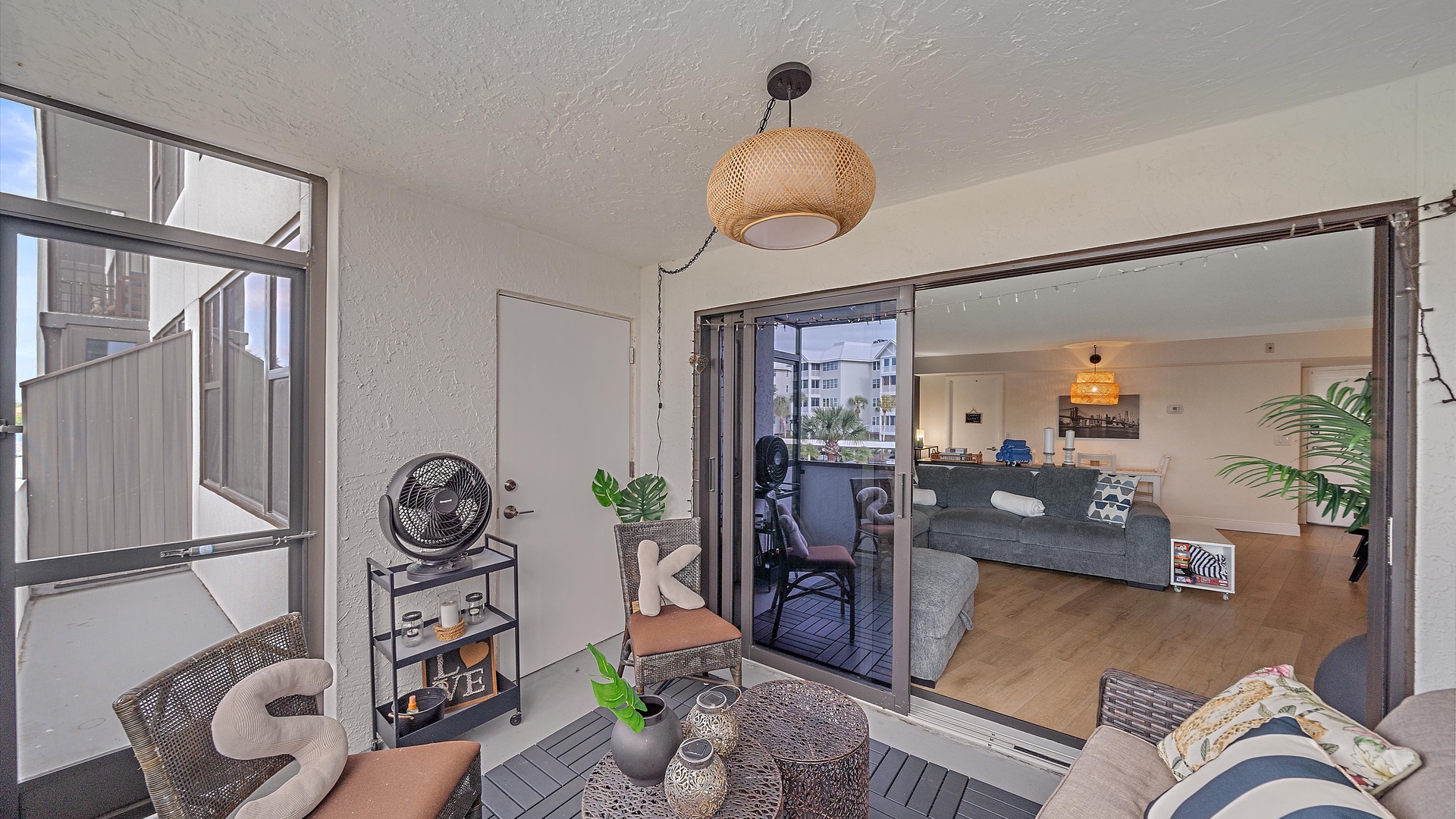 Relax on your private balcony with stylish furnishings and rattan lighting, seamlessly connecting to your bright living space through sliding doors.