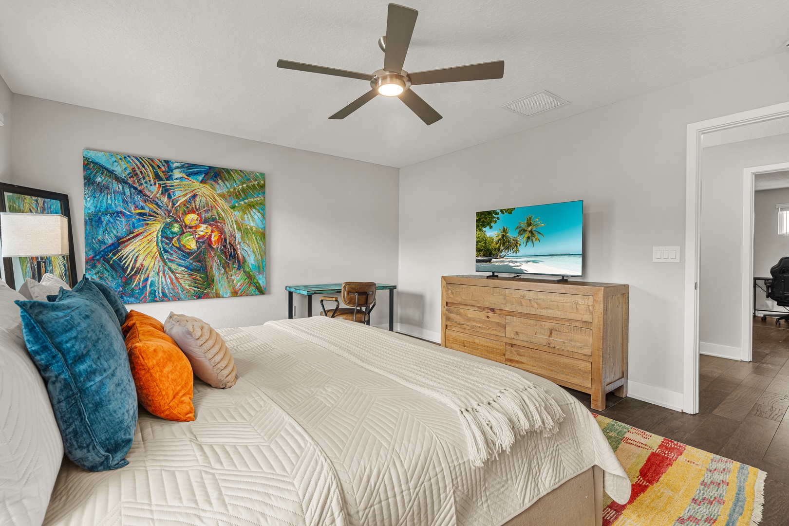 Unwind in the primary king bedroom with hotel-style linens, ensuite bathroom and soaking tub, plush towels, and Smart TV.