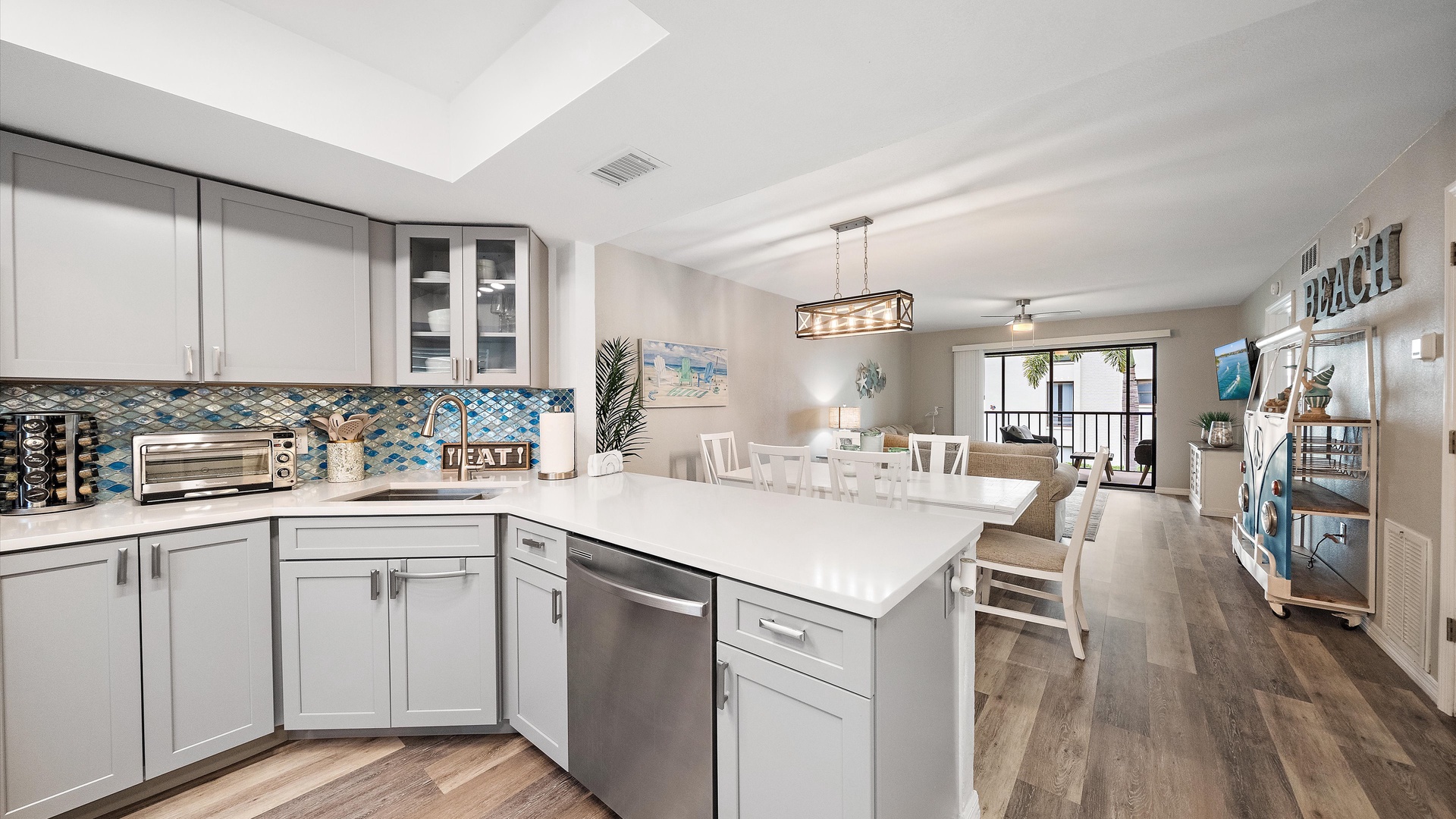 Your bright coastal kitchen flows seamlessly into the dining space, ready for lazy mornings and lively dinners. Sleek countertops and beach-inspired touches invite you to whip up your favorite meals while vacation mode kicks in.