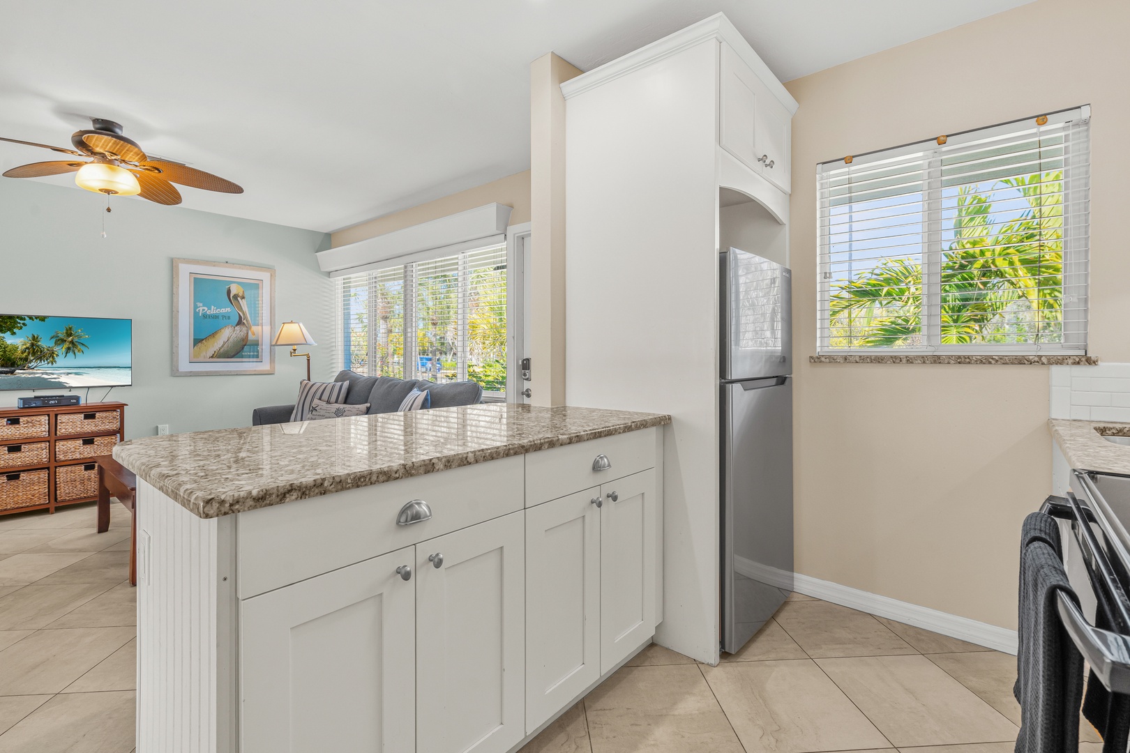 Your fully equipped kitchen features granite countertops and stainless appliances, perfect for preparing tropical meals while enjoying garden views.