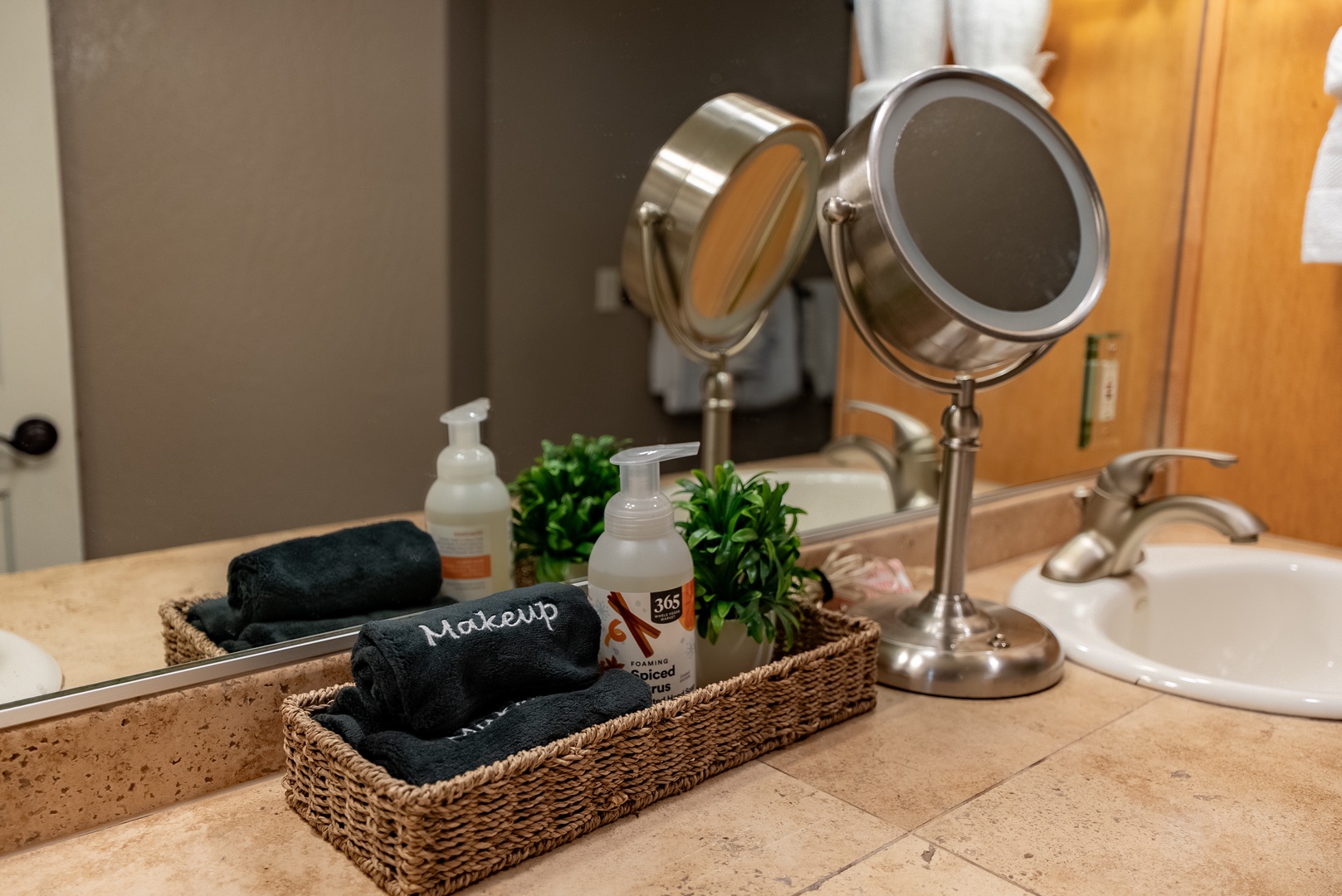 Pamper yourself in this thoughtfully designed bathroom with luxe amenities, folded towels, and a lighted vanity mirror for your morning routine.