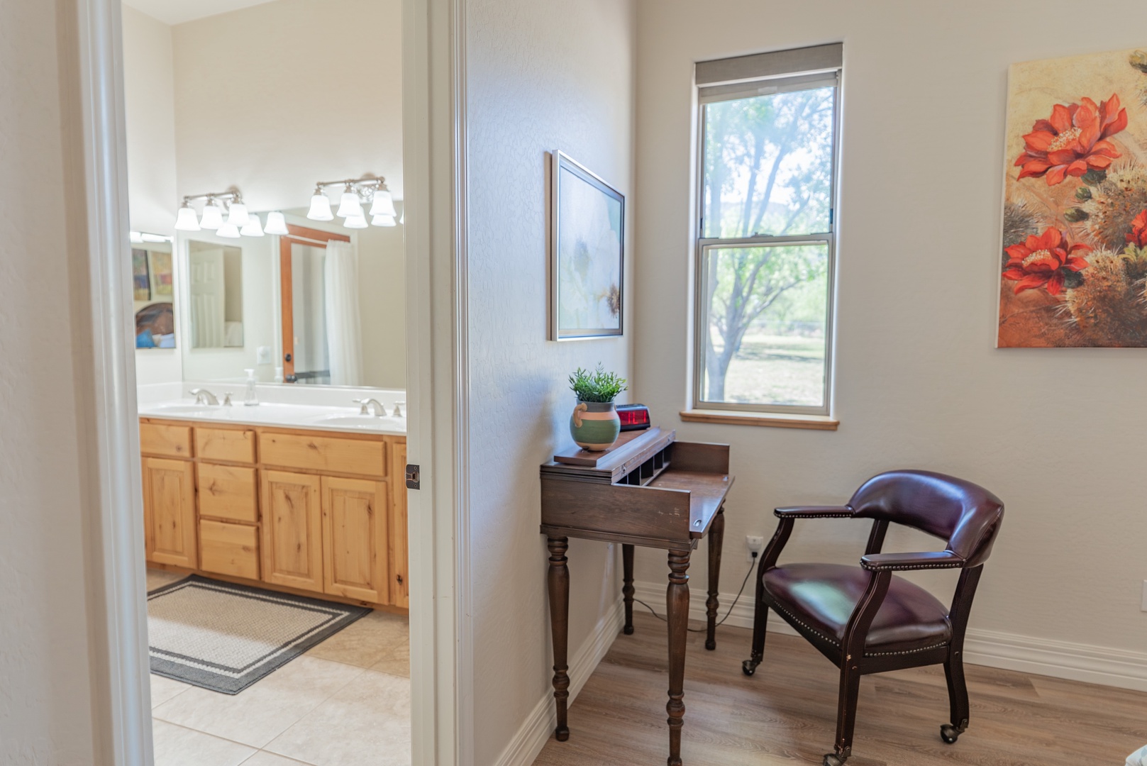 Your charming workspace overlooks peaceful trees, while the adjoining bathroom offers comfort and convenience for your stay.