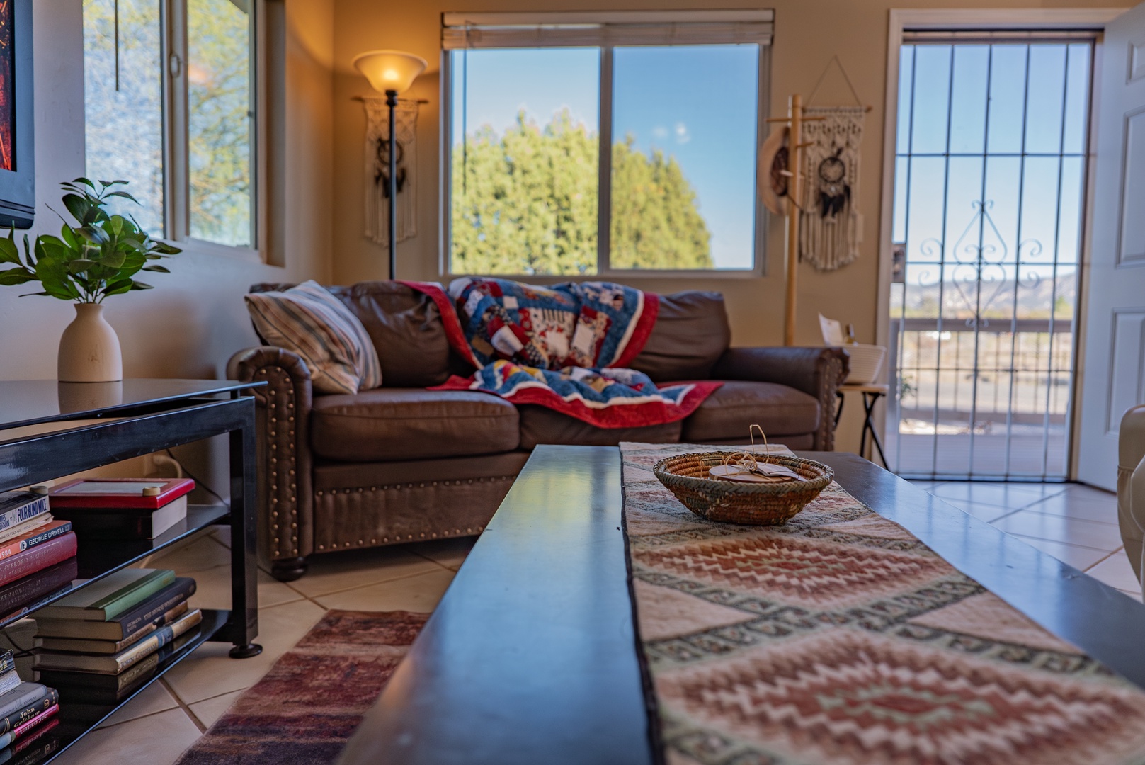 Relax in your comfortable living room with cozy furnishings, natural light streaming through large windows, and thoughtful touches that make you feel right at home.