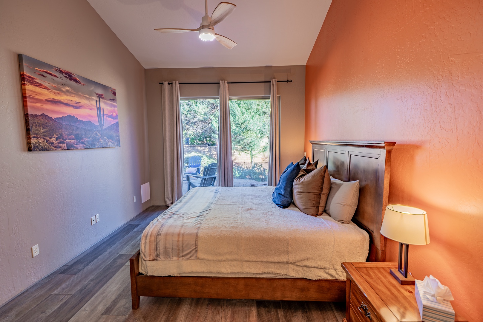 Drift off in your cozy bedroom featuring warm desert tones, soft linens, and peaceful patio views.