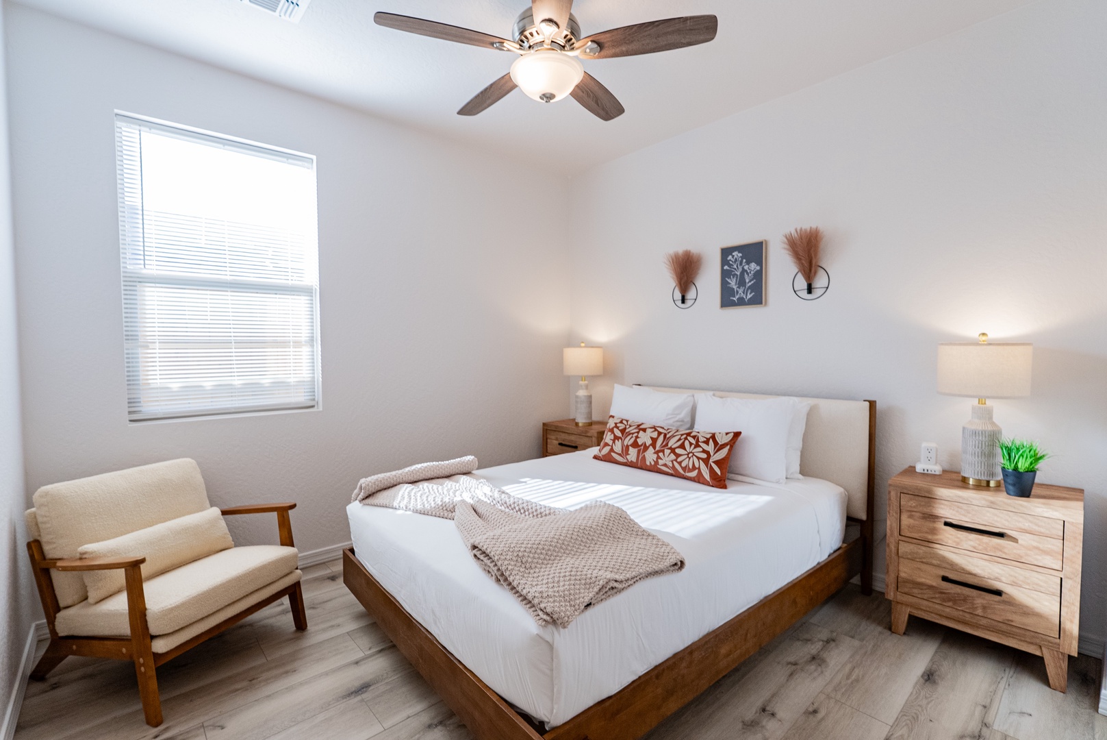 Crisp white linens and warm wood tones in serene bedroom