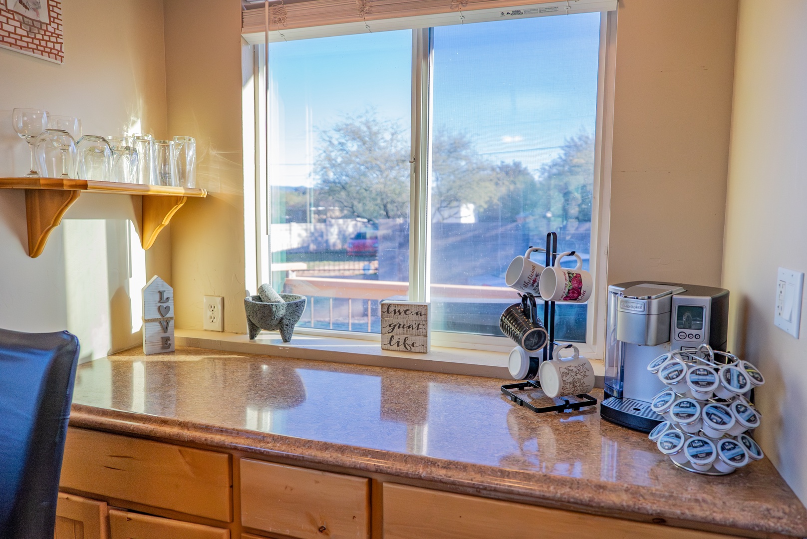 Your kitchen features everything you need for a comfortable stay, with coffee facilities, glassware, and a peaceful view to brighten your mornings.
