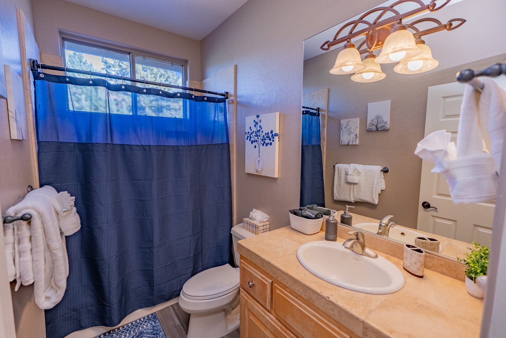 Your private bathroom offers warm lighting and fresh towels, creating a cozy retreat after your adventures.