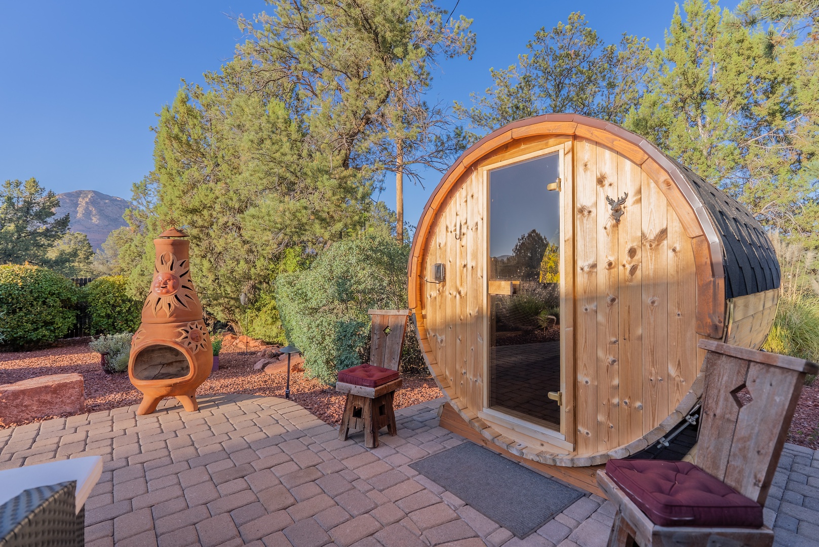 Barrel-shaped sauna with interior windows to take in the red rocks