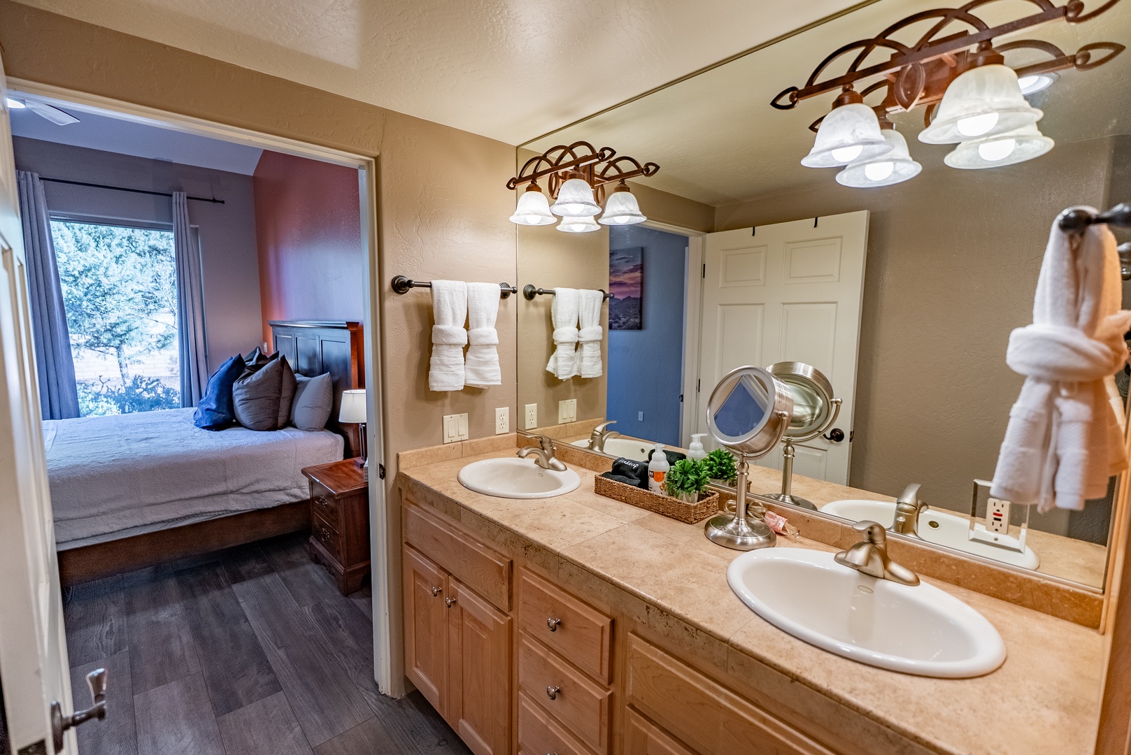 Private en-suite bathroom with dual sinks and large walk-in closet.