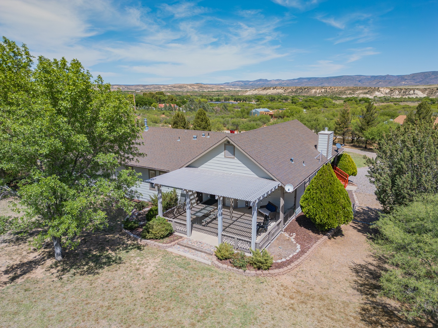 Peaceful desert retreat with mountain views and charming covered porch, nestled in scenic countryside near community amenities.