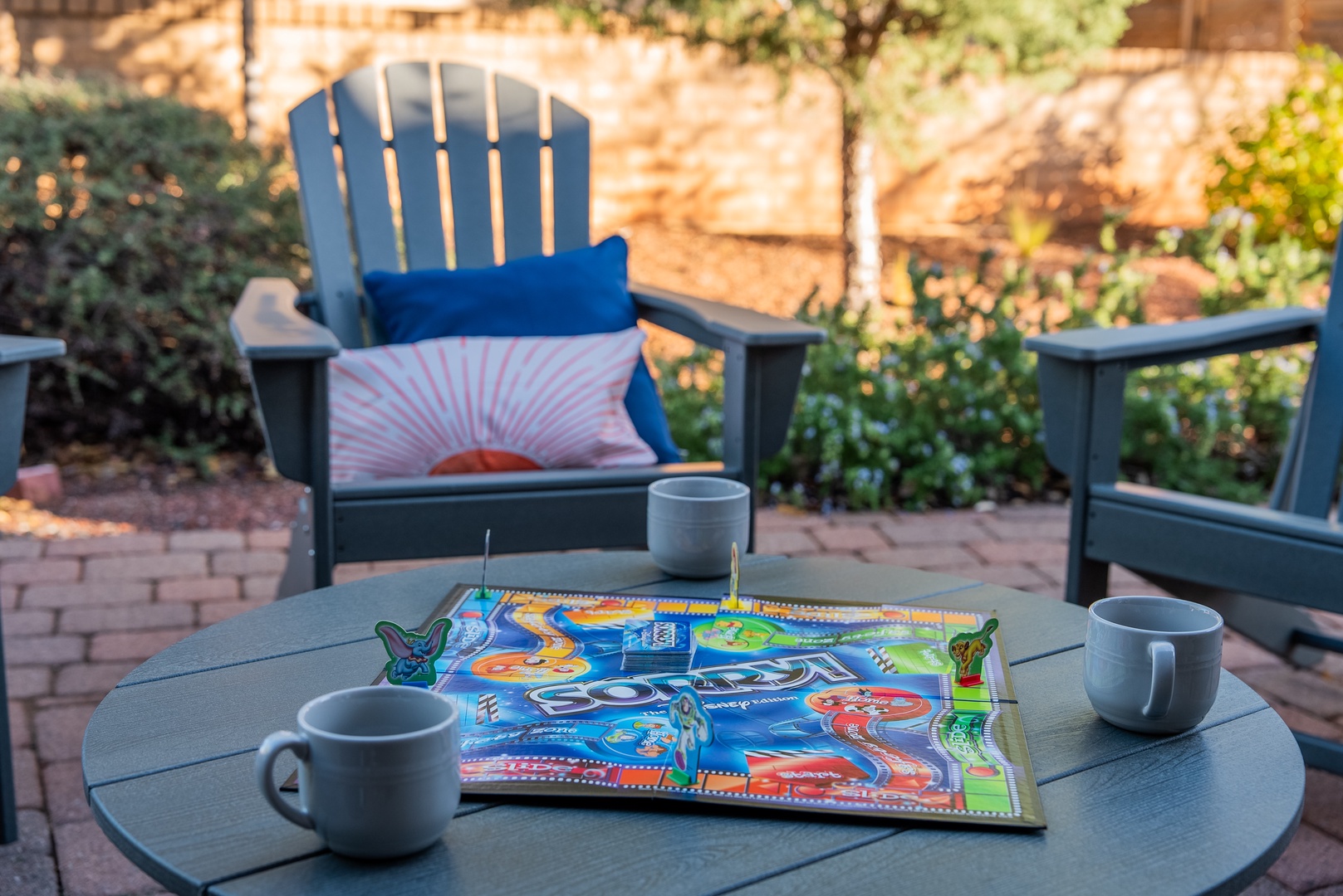 Start your morning with coffee and games on your private patio, surrounded by lush gardens and warm brick pathways.