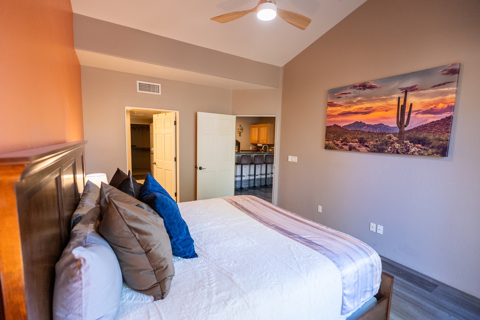 Sink into your cozy bedroom sanctuary with crisp linens and stunning desert artwork creating the perfect retreat.