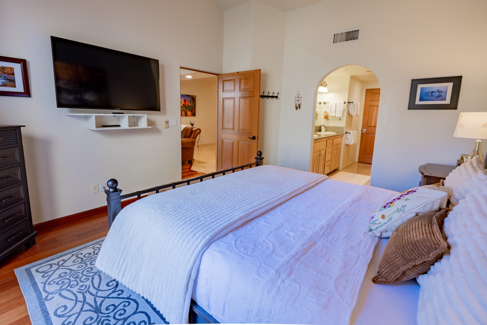 Unwind in your spacious master suite with plush bedding, wall-mounted TV, and elegant ensuite bathroom just steps away.
