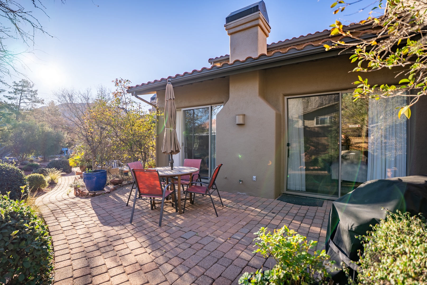 Step onto your private patio where morning coffee and evening dinners feel extra special on beautiful brick pavers surrounded by lush gardens.