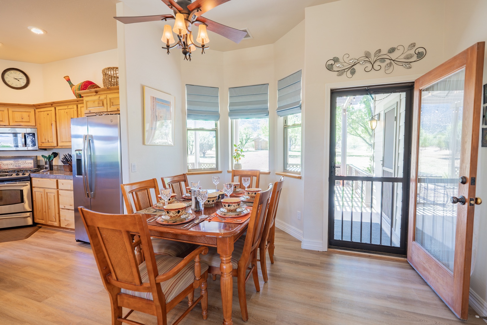 Gather around the dining table where conversations flow naturally in warm, sunlit comfort.