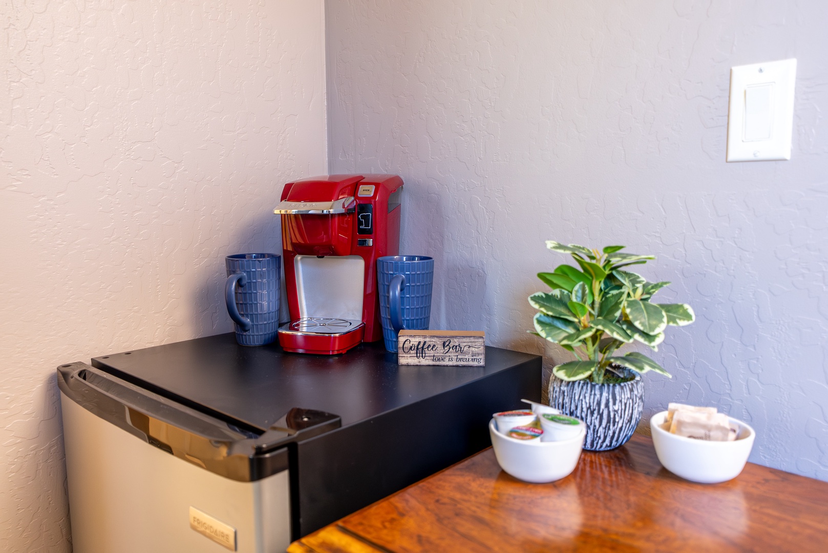 Upstairs coffee bar with mini fridge for morning convenience.