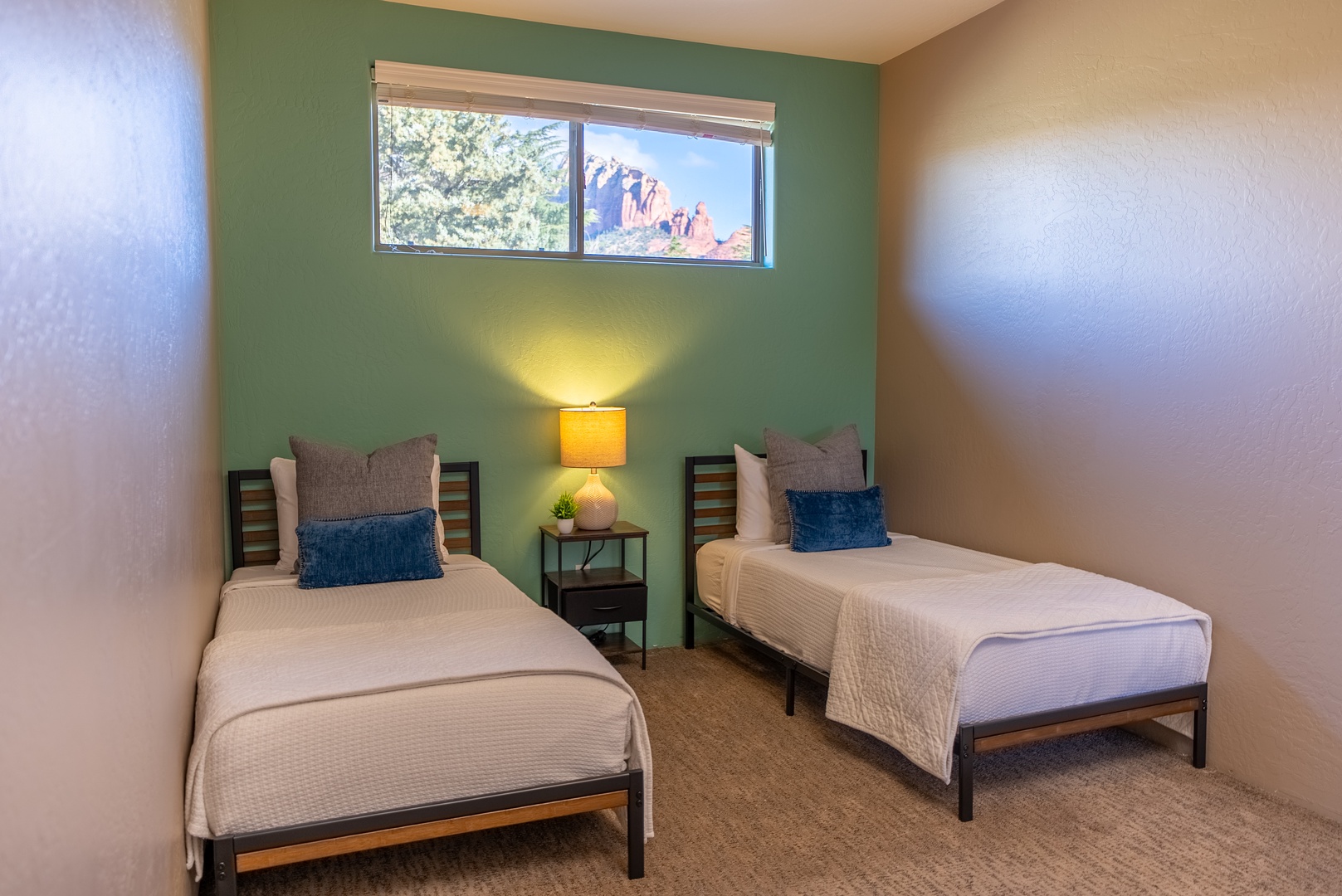 Rest peacefully in your twin bedroom with crisp linens and stunning red rock views through your window.