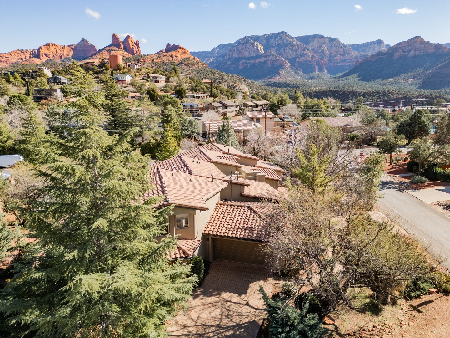 Stunning aerial view of Sedona's red rock formations surrounding this charming property nestled in the high desert landscape.