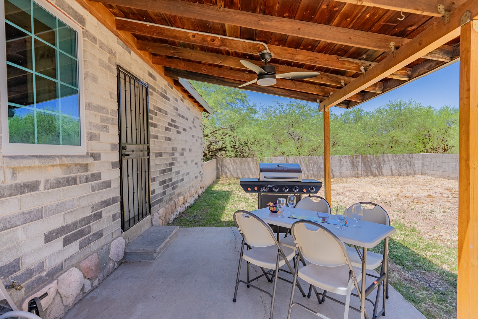 Private back patio with fan and grill