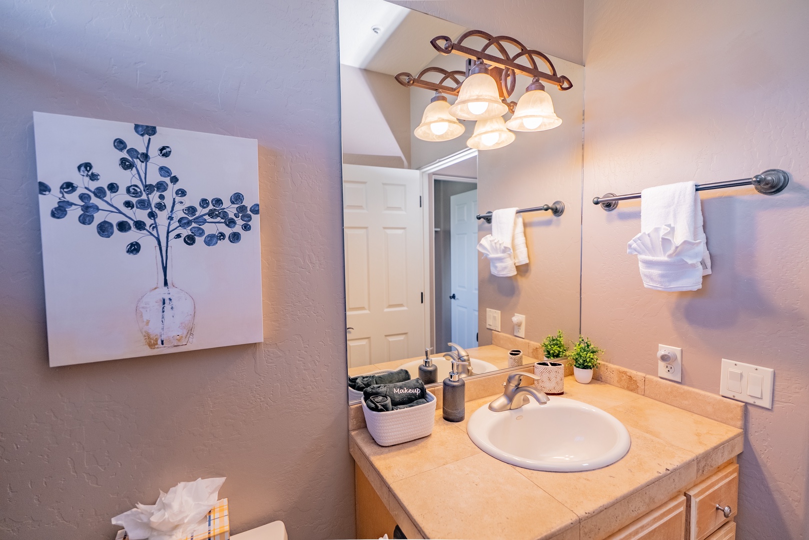 Your private bathroom features warm lighting and thoughtful touches, with fresh towels and amenities perfectly arranged for your comfort.