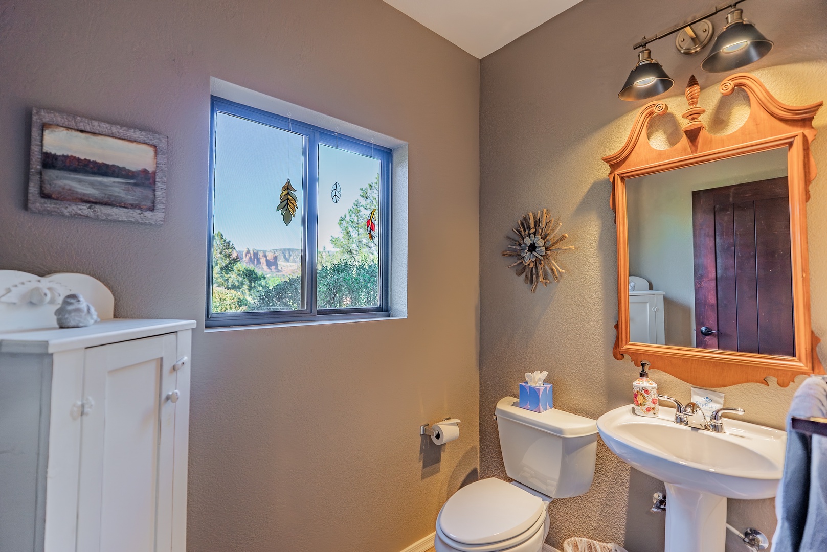 Guest bath off of living and laundry area has views out back.