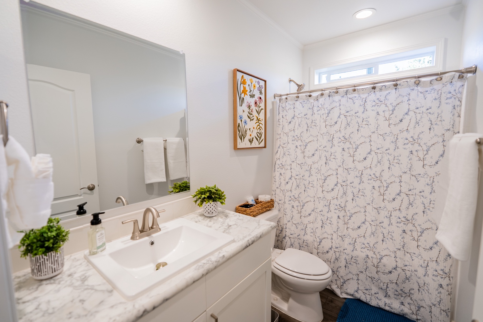 Well appointed bathroom with botanical theme.
