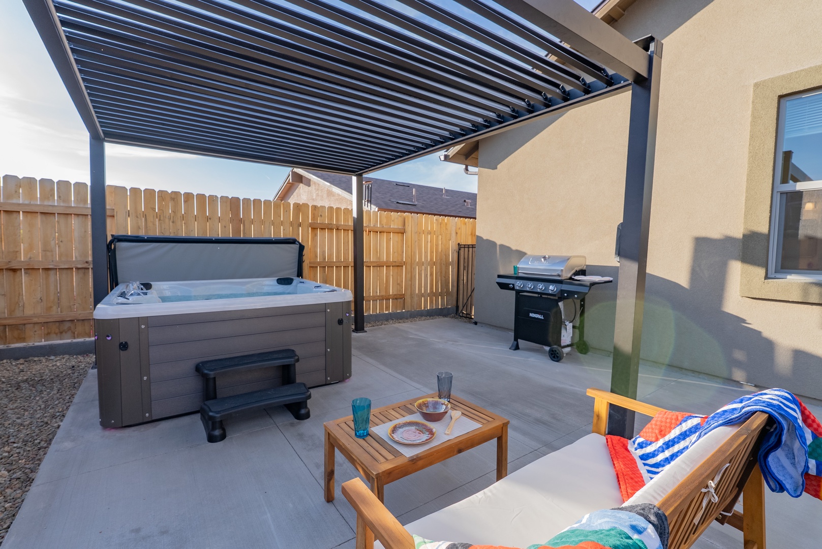 Unwind in your private backyard tub and BBQ grill