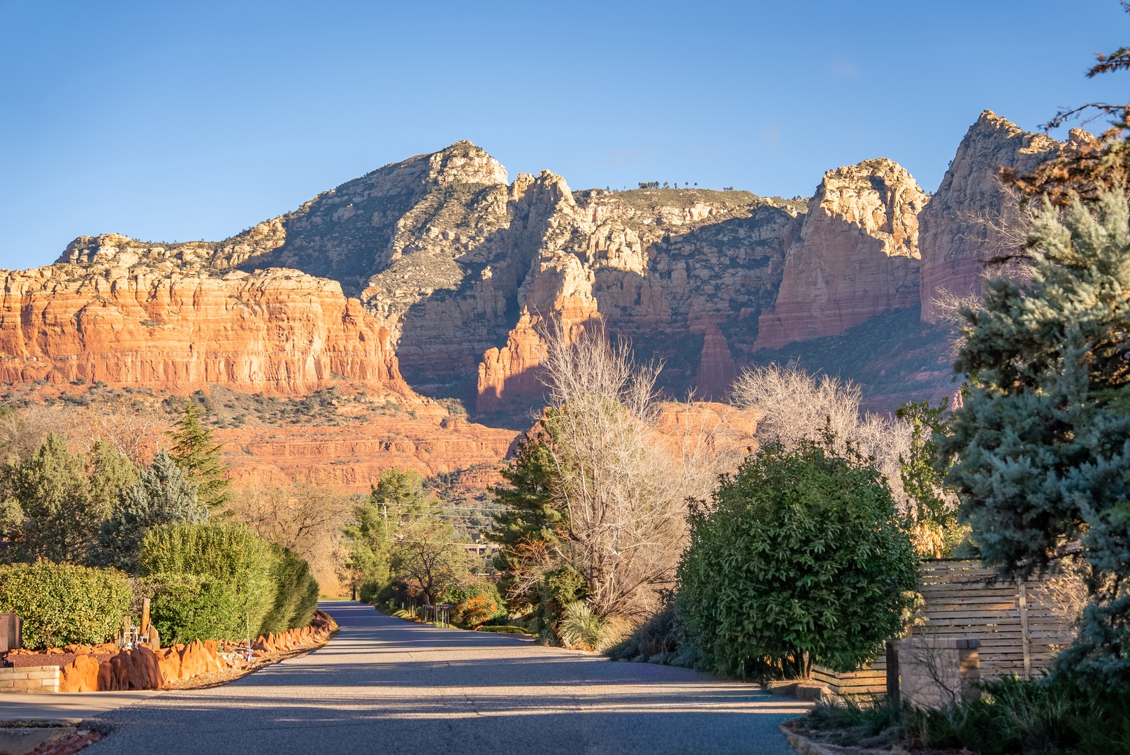 Stunning red rock formations create a dramatic backdrop in this scenic desert neighborhood setting.