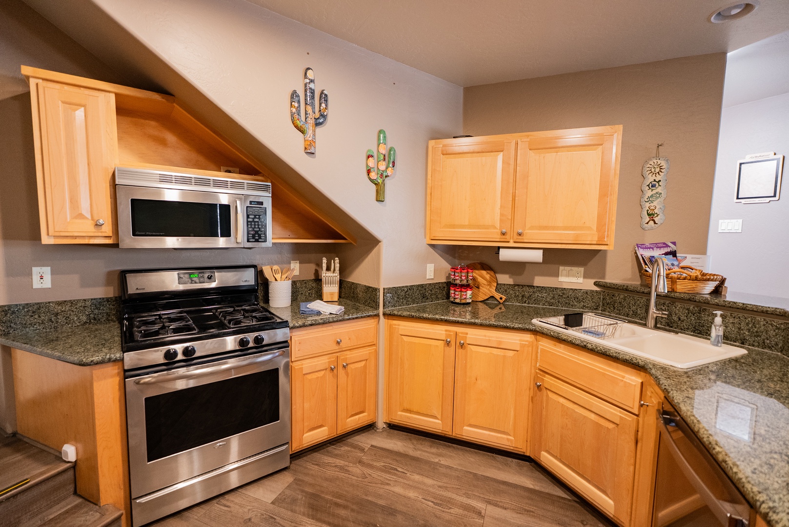 Your fully equipped kitchen features granite counters and stainless appliances, ready for preparing meals.