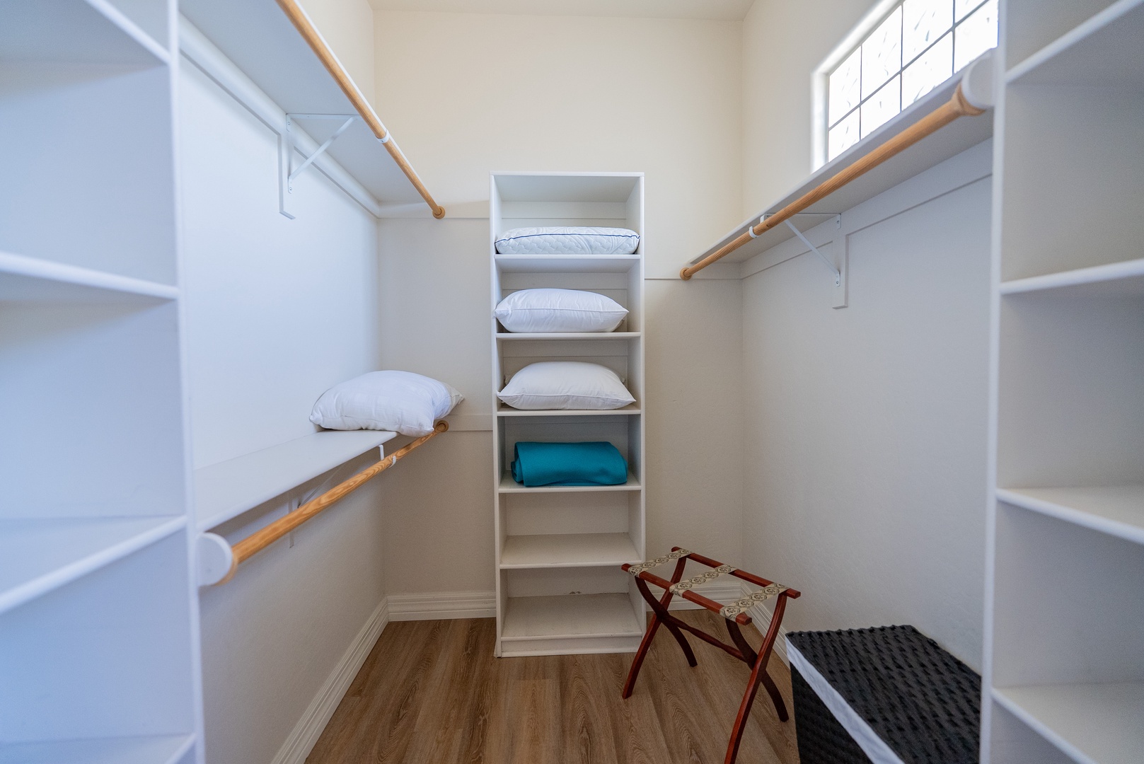 Your spacious walk-in closet offers plenty of room to organize your wardrobe with built-in shelving and hanging space.