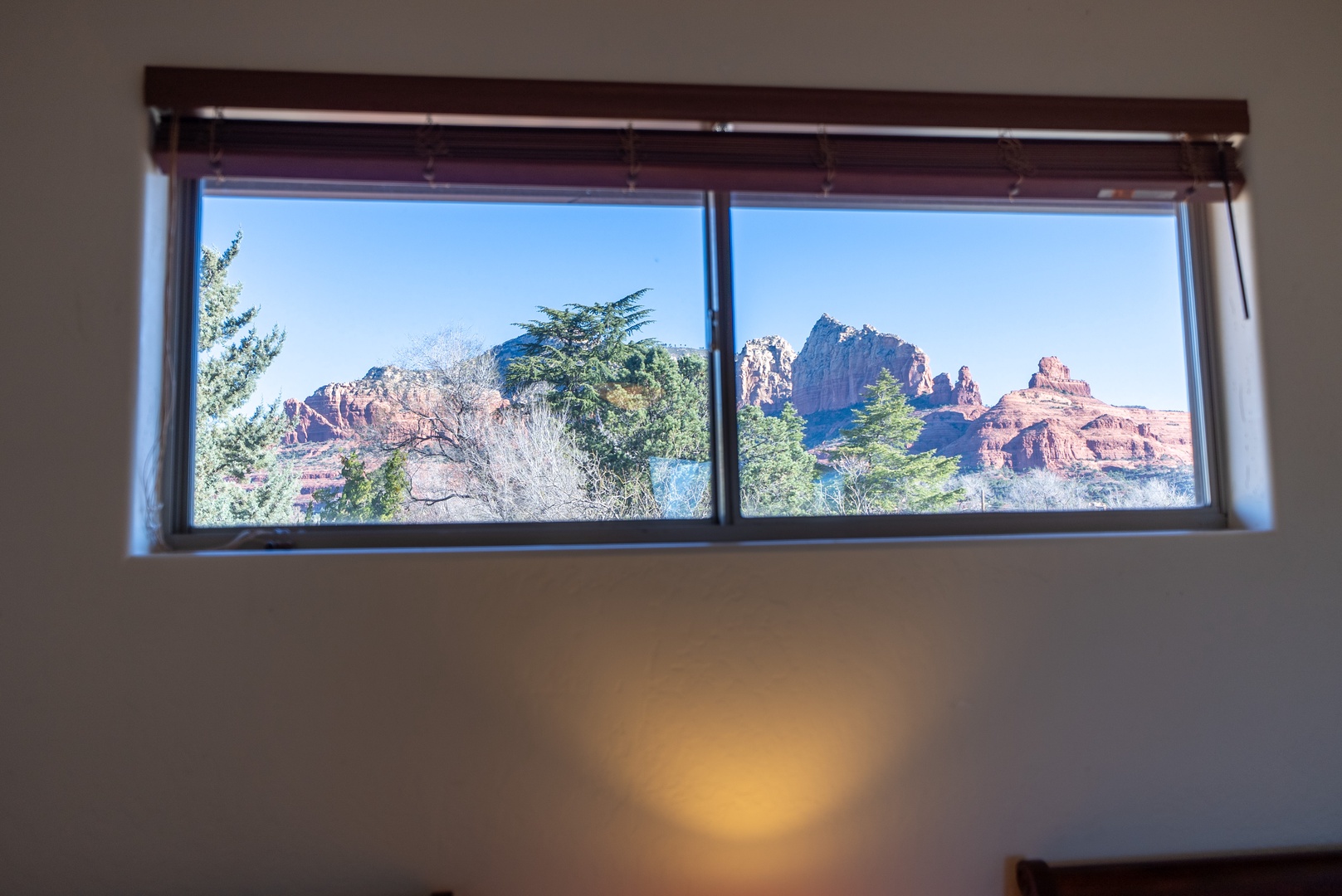 Wake up to breathtaking red rock formations framed perfectly through your bedroom window—nature's masterpiece greets you every morning.