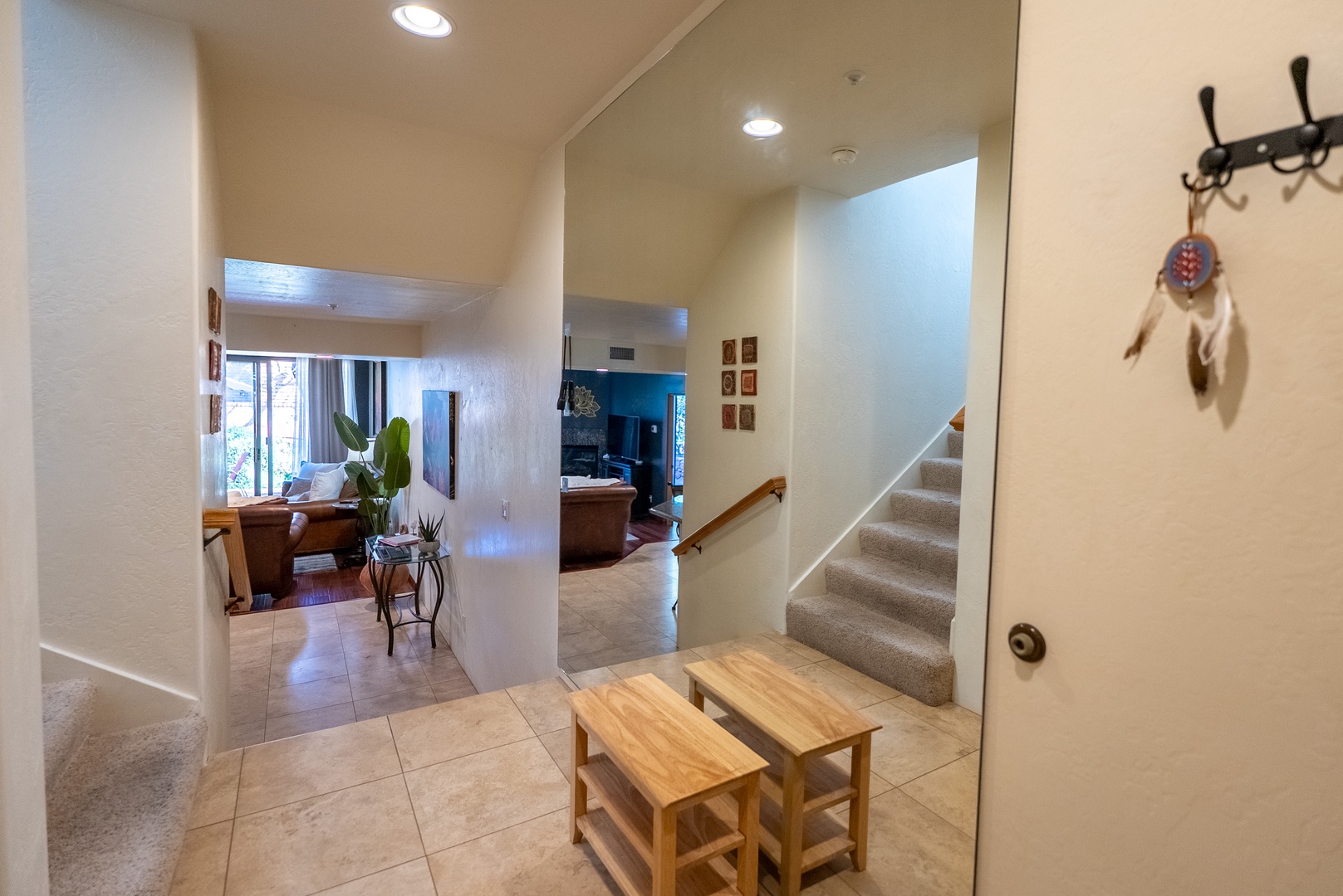 Step into your welcoming entryway where thoughtful touches like decorative hooks and warm lighting create an instantly comfortable atmosphere for your getaway.