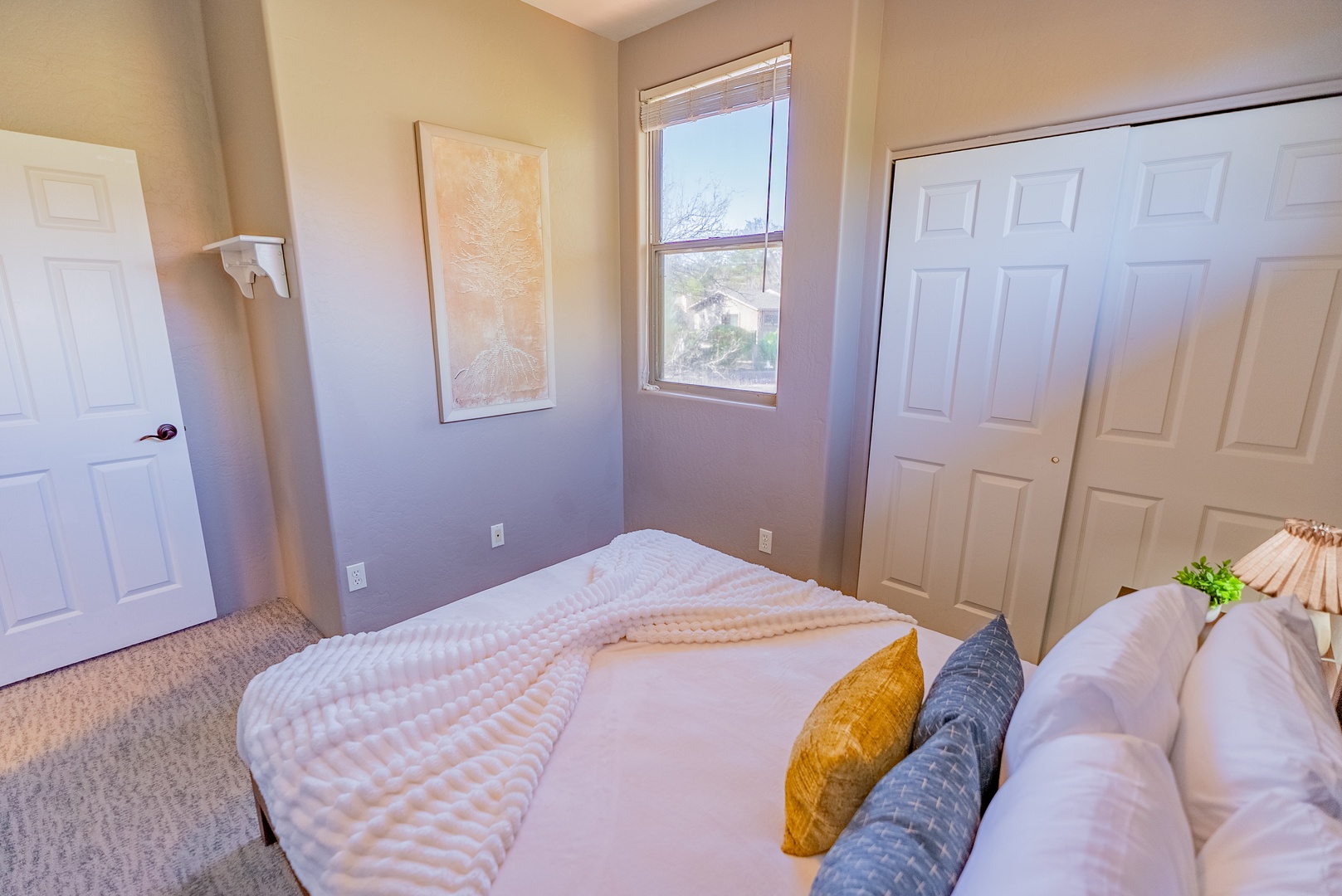 Sink into soft linens and wake to peaceful neighborhood views in your cozy bedroom retreat.