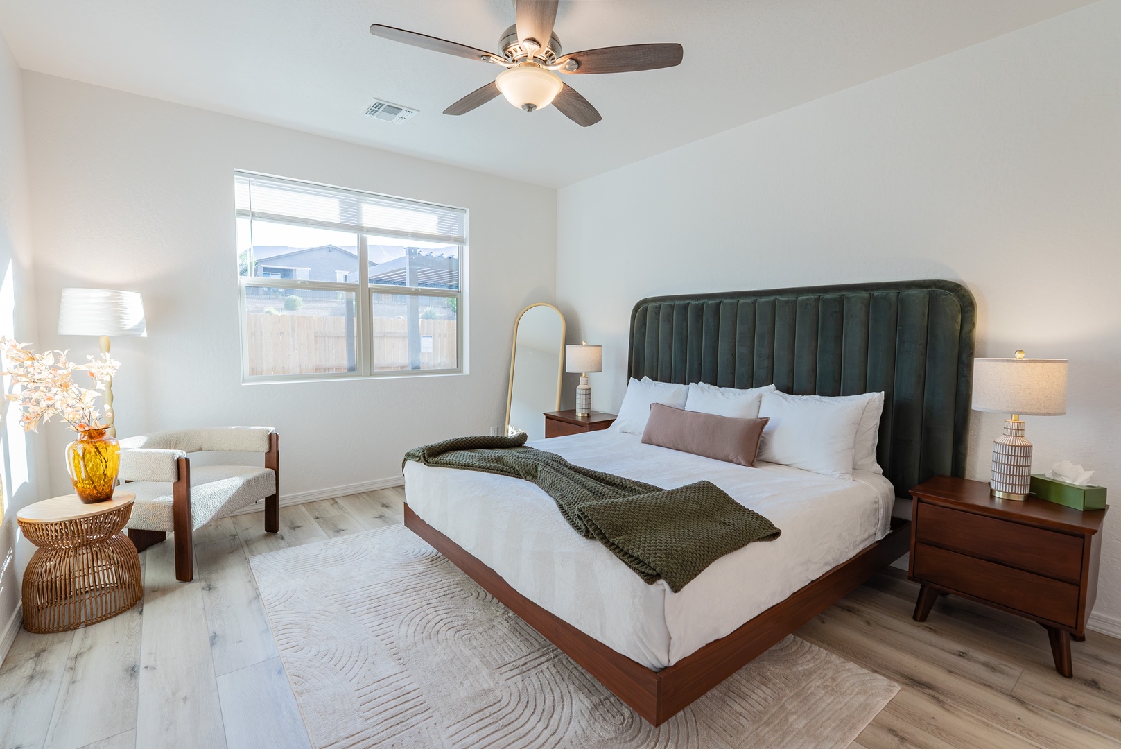 Sink into your plush king bed with elegant green headboard