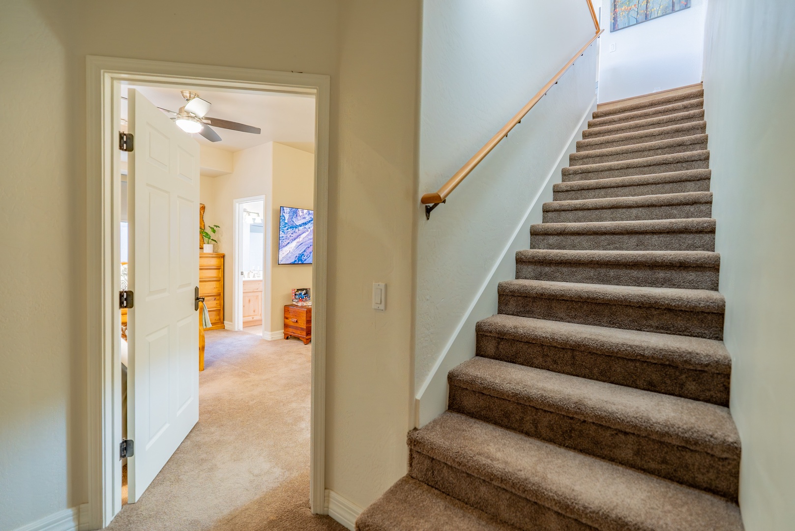 Step into your inviting multi-level home where carpeted stairs lead to private spaces above while open living areas await below.