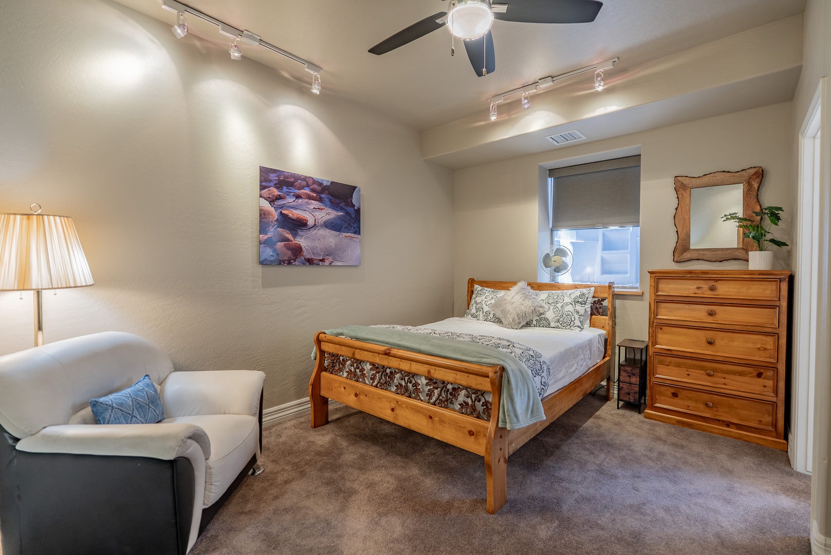 Sink into your cozy bedroom sanctuary with warm wood furnishings, plush seating, and thoughtful lighting for the perfect retreat.